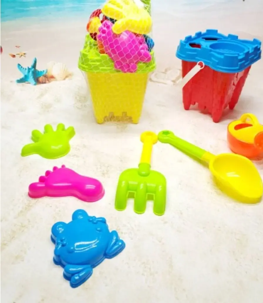 Beach sand set in a net bag, spade and moulds